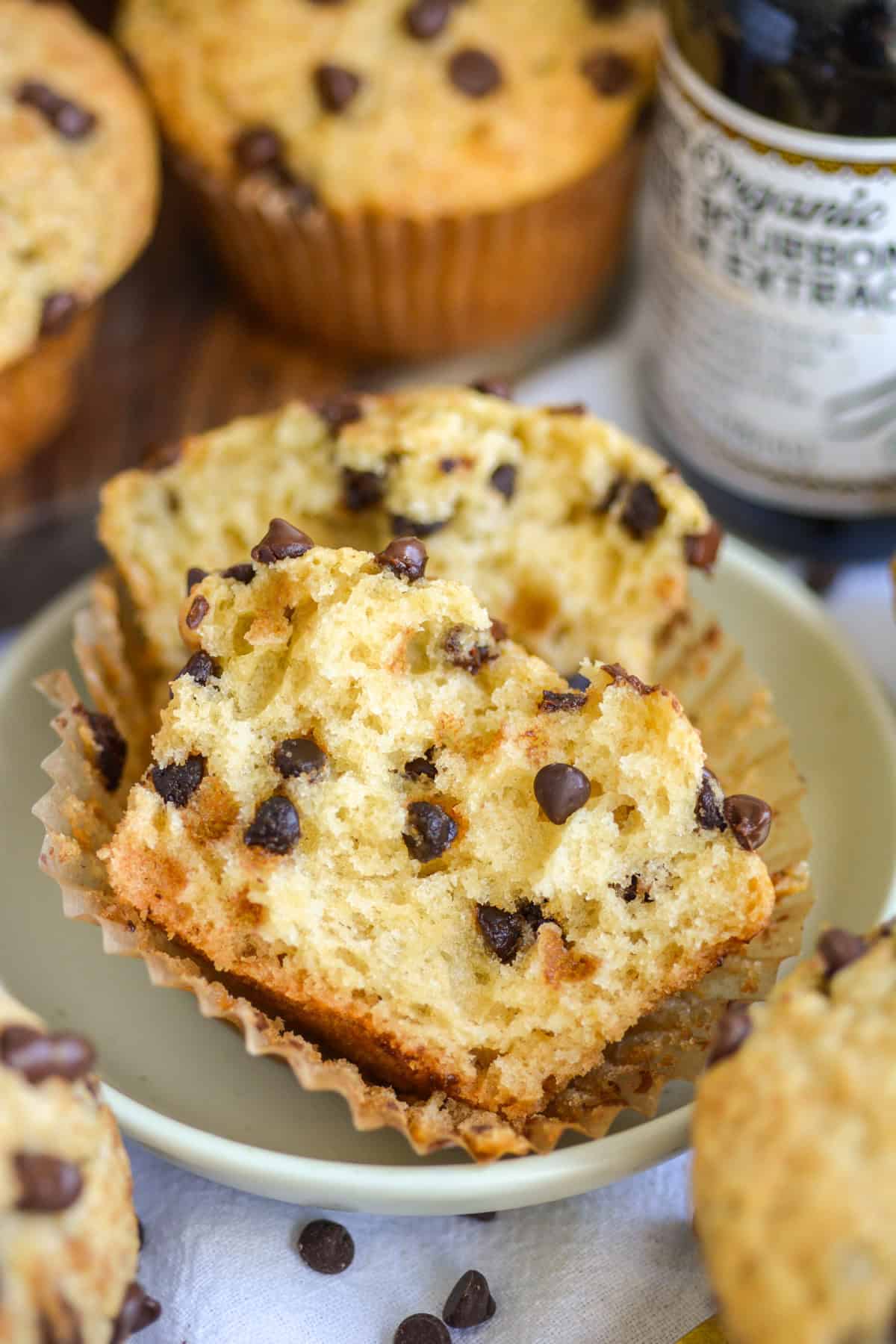 A Vegan Chocolate Chip Muffin cut in half on a small plate.