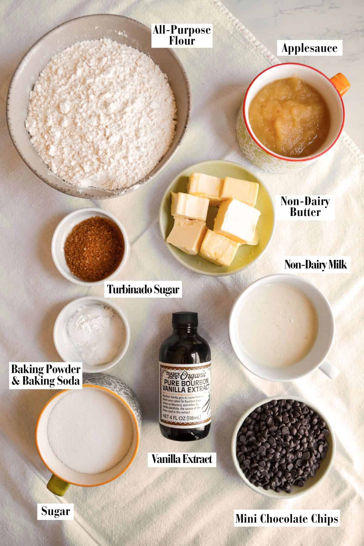 Ingredients in small bowls on a linen surface.