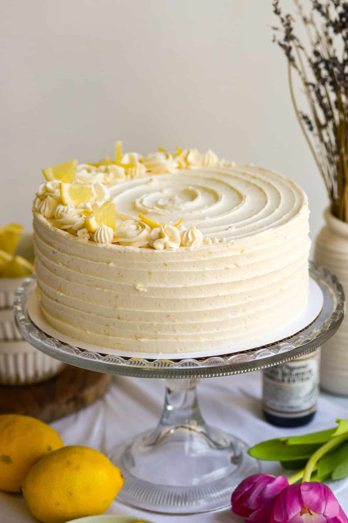 A Vegan Lemon Layer Cake on a cake stand.