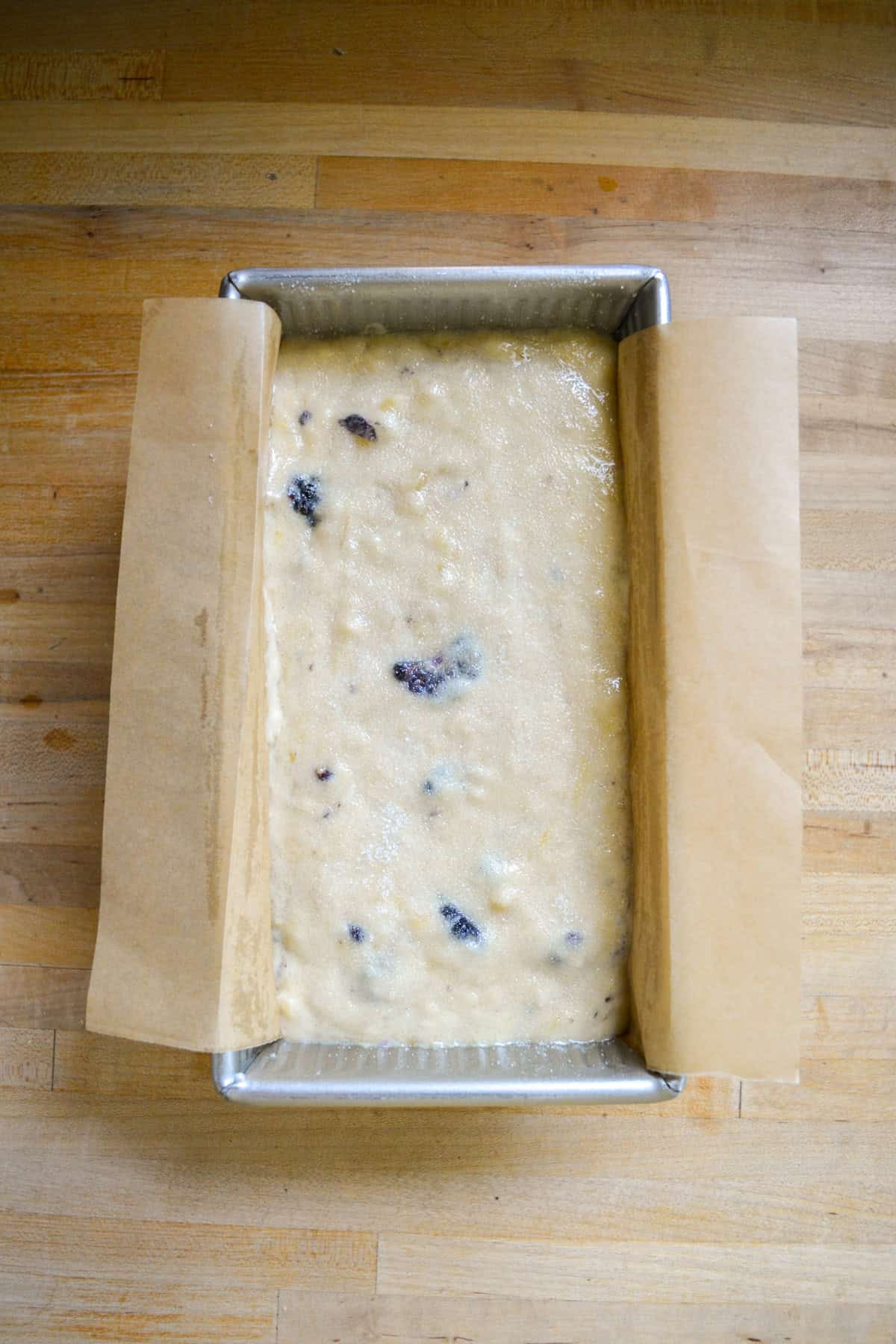 Blackberry banana bread batter in a loaf pan.