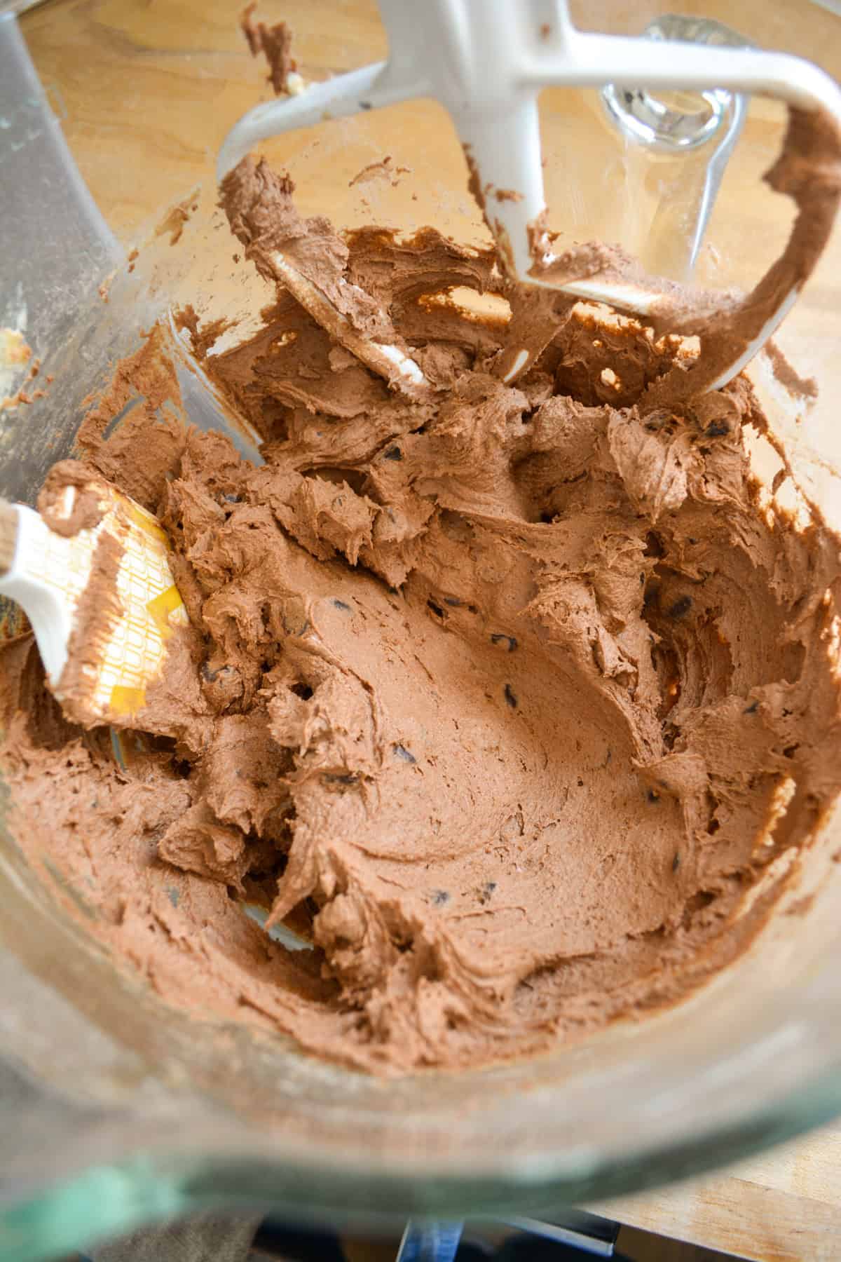 Chocolate cookie dough in a glass bowl.