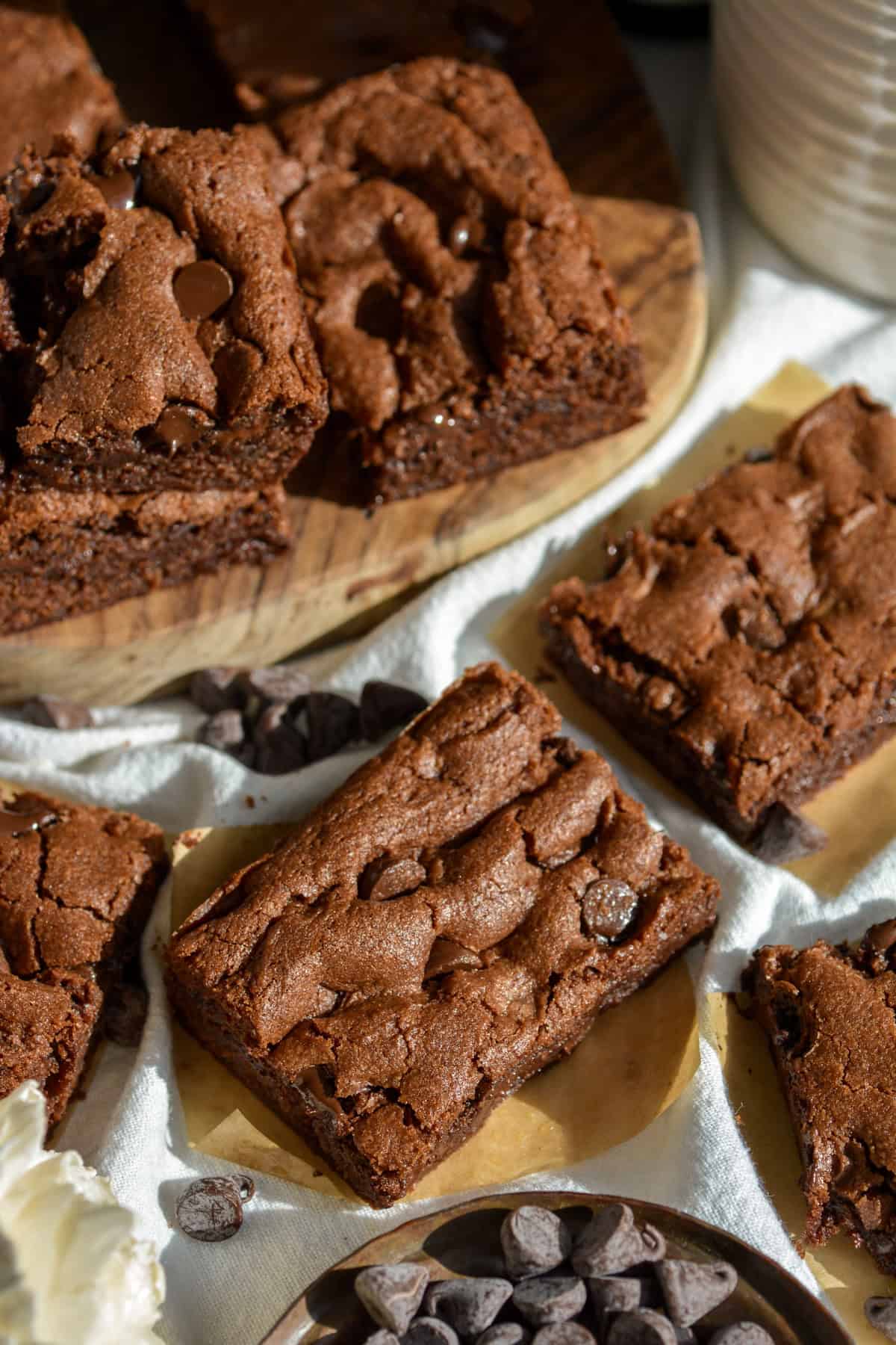 Chocolate Chocolate Chip Cookie Bars on a linen surface.