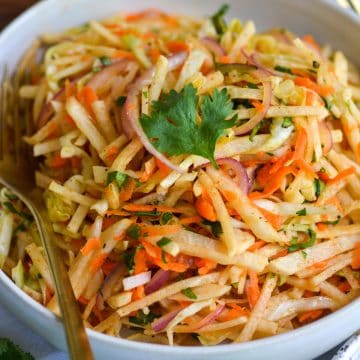 Jicama Slaw in a bowl topped with cilantro.