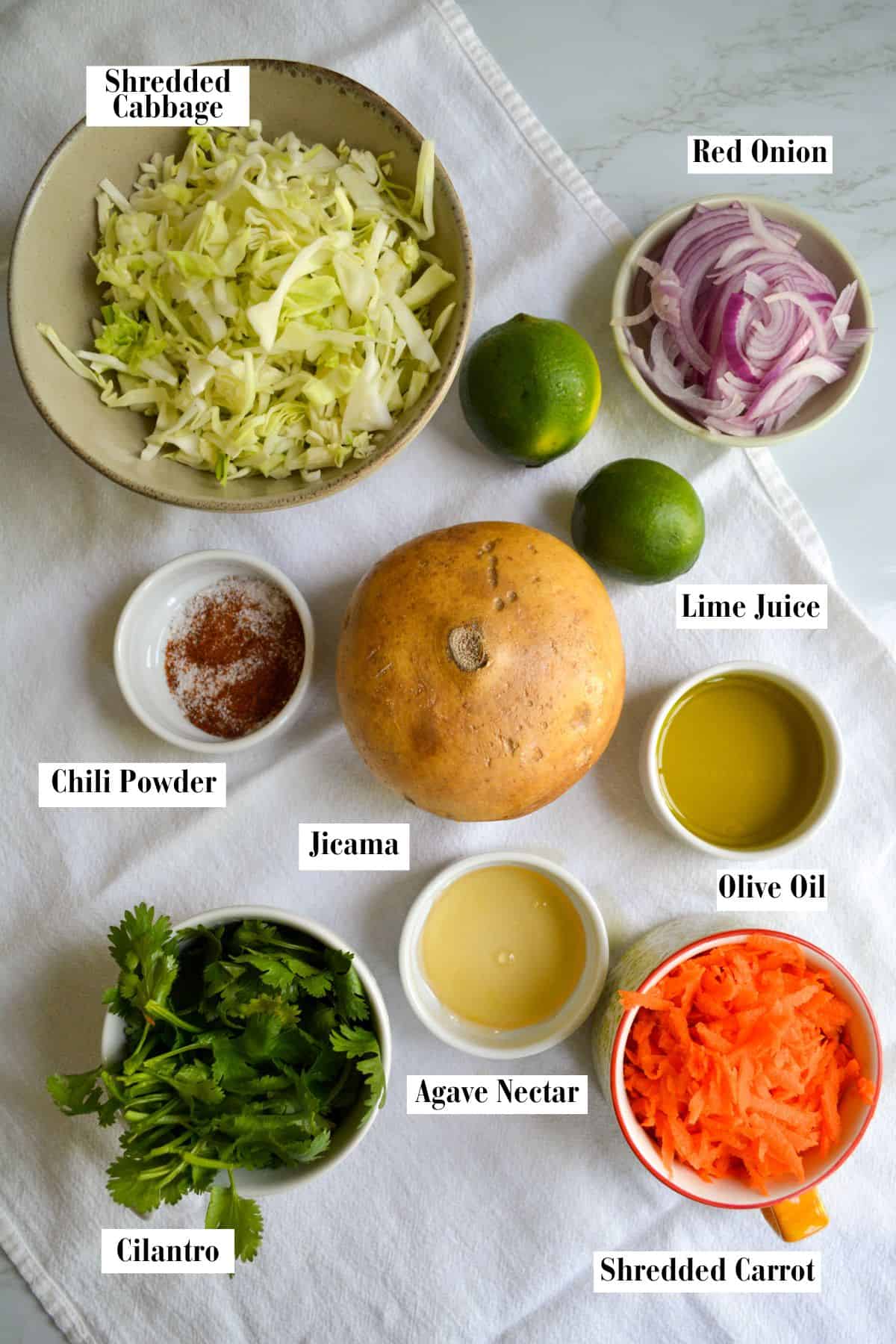 Ingredients for this recipe in small bowls on a linen surface.