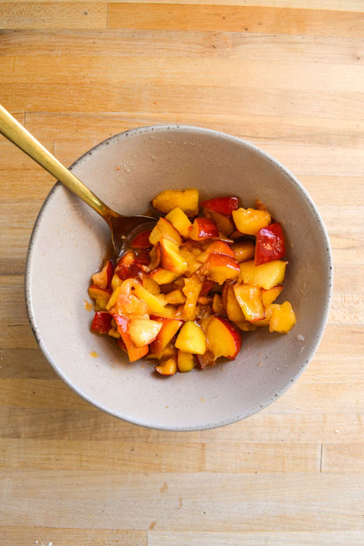 Macerated peaches in a bowl.