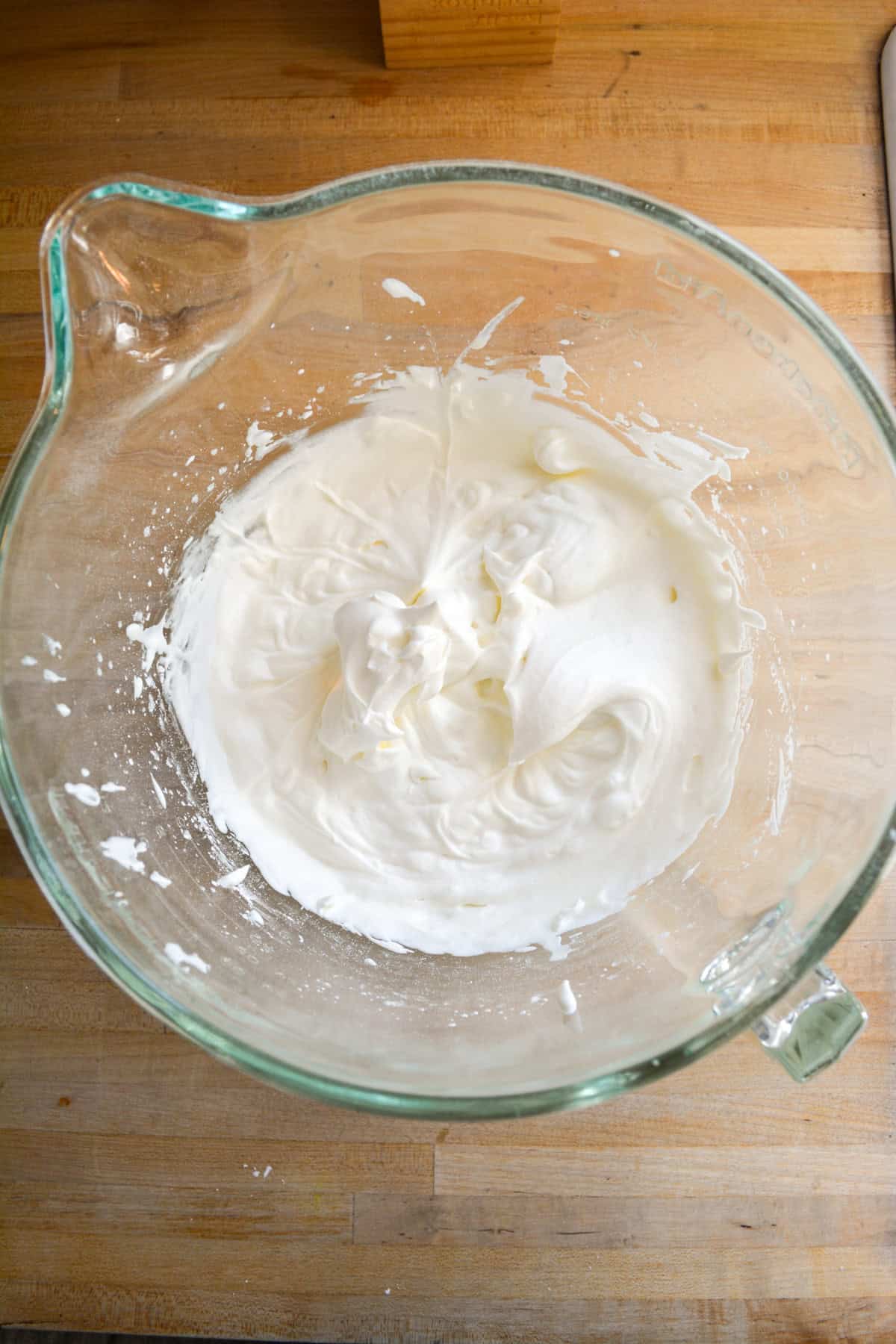 Whipped cream in a glass bowl.
