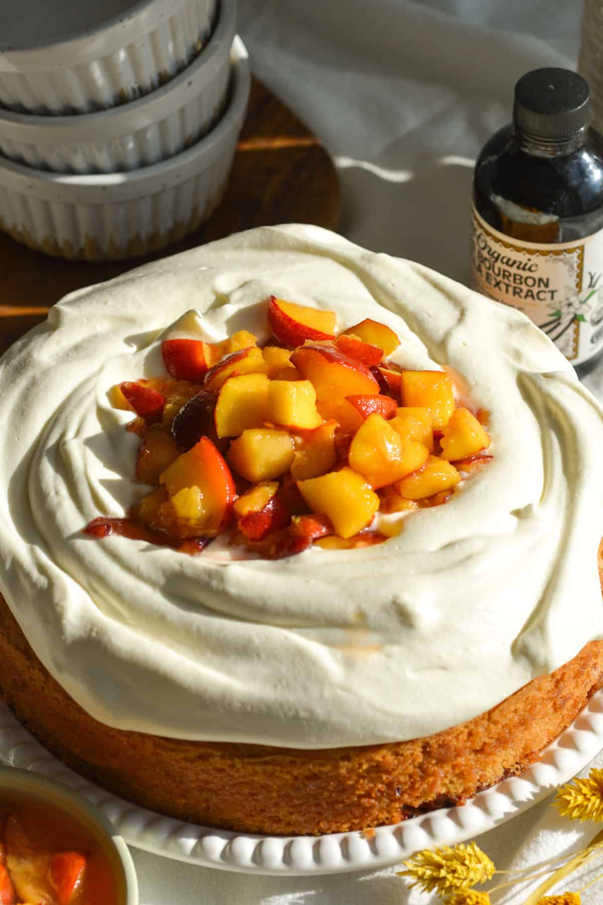 Peach cake toped with whipped cream and macerated peaches.