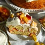 A slice of peaches and cream cake on a small plate.