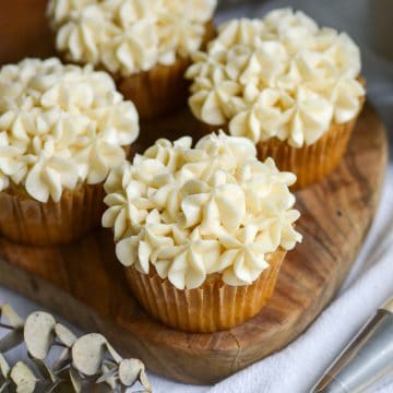 Vegan vanilla frosting piped onto cupcakes.