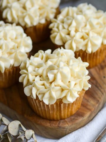 Vegan vanilla frosting piped onto cupcakes.