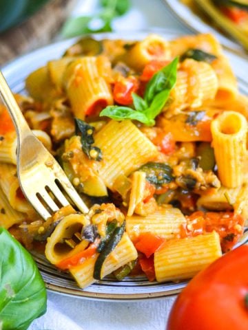 A fork with a bite of Creamy Roasted Vegetable Pasta on it.