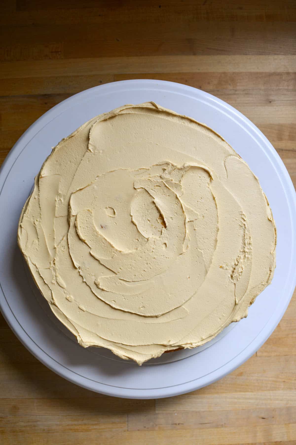 A Vegan Pumpkin Cake layer topped with brown sugar frosting.