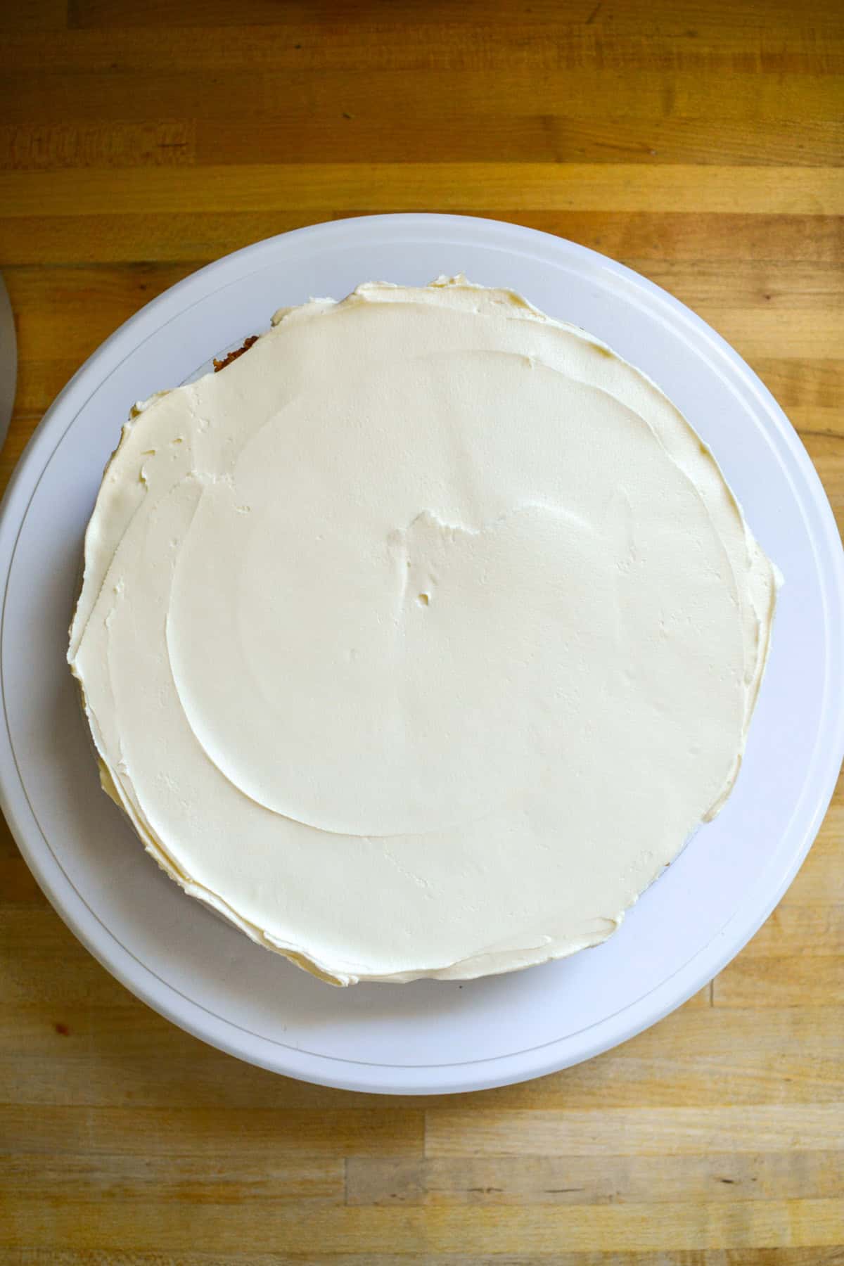 Frosting spread onto a cake layer.