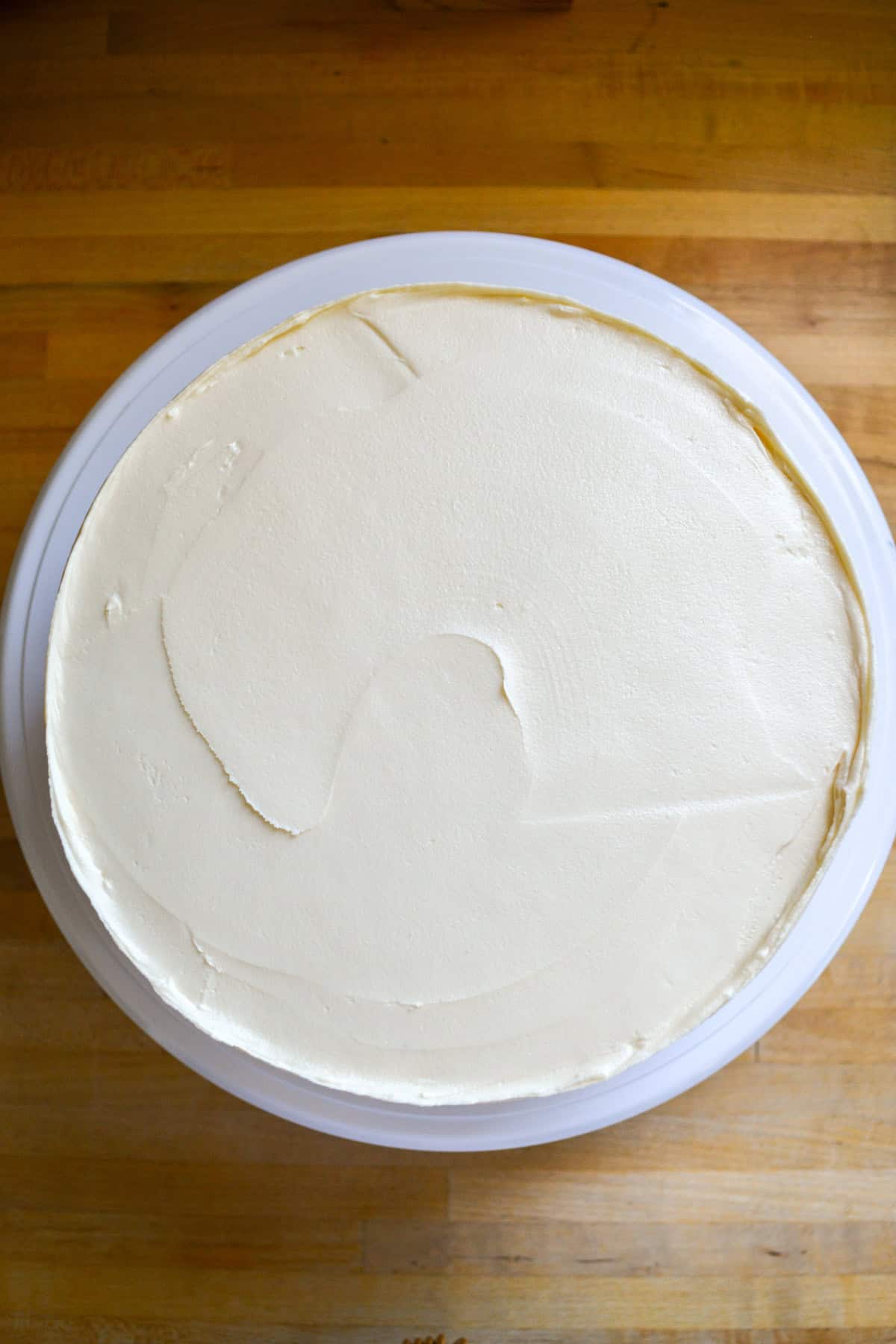 A frosted cake on a turntable.