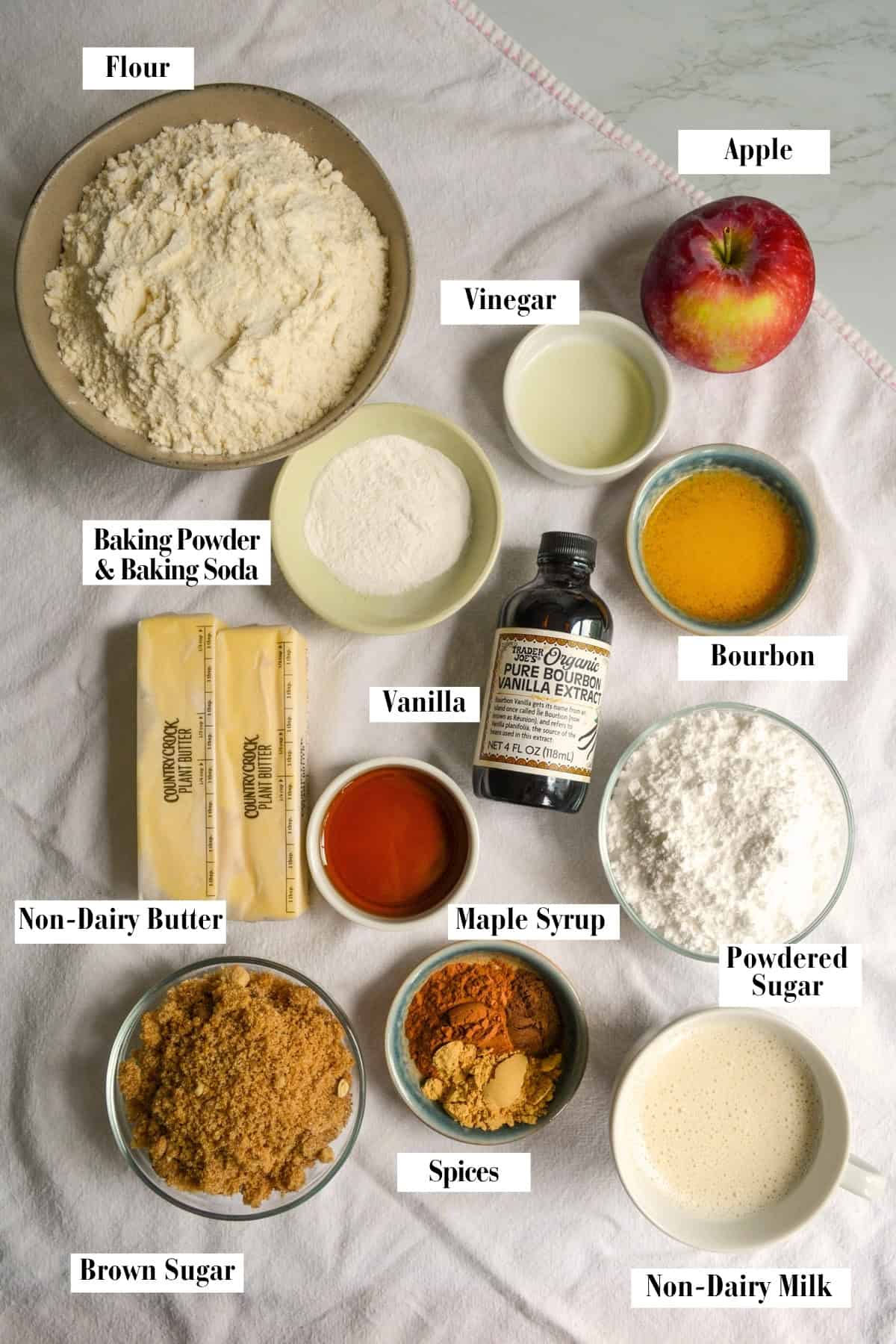 Ingredients for making this recipe in small bowls on a linen surface.