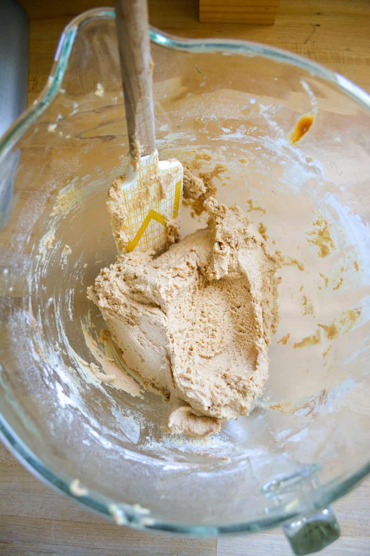 Cookie dough in a glass mixing bowl.