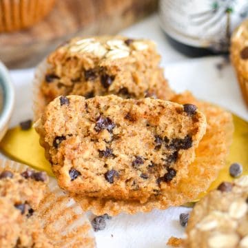 An Oat Flour Chocolate Chip Muffin brown in half to show the fluffy interior.