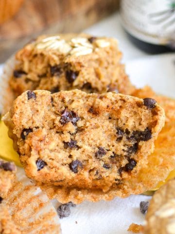 An Oat Flour Chocolate Chip Muffin brown in half to show the fluffy interior.