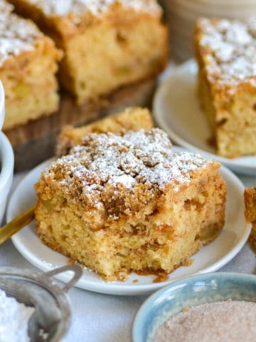 A piece of Vegan Apple Crumb Cake on a small white plate.