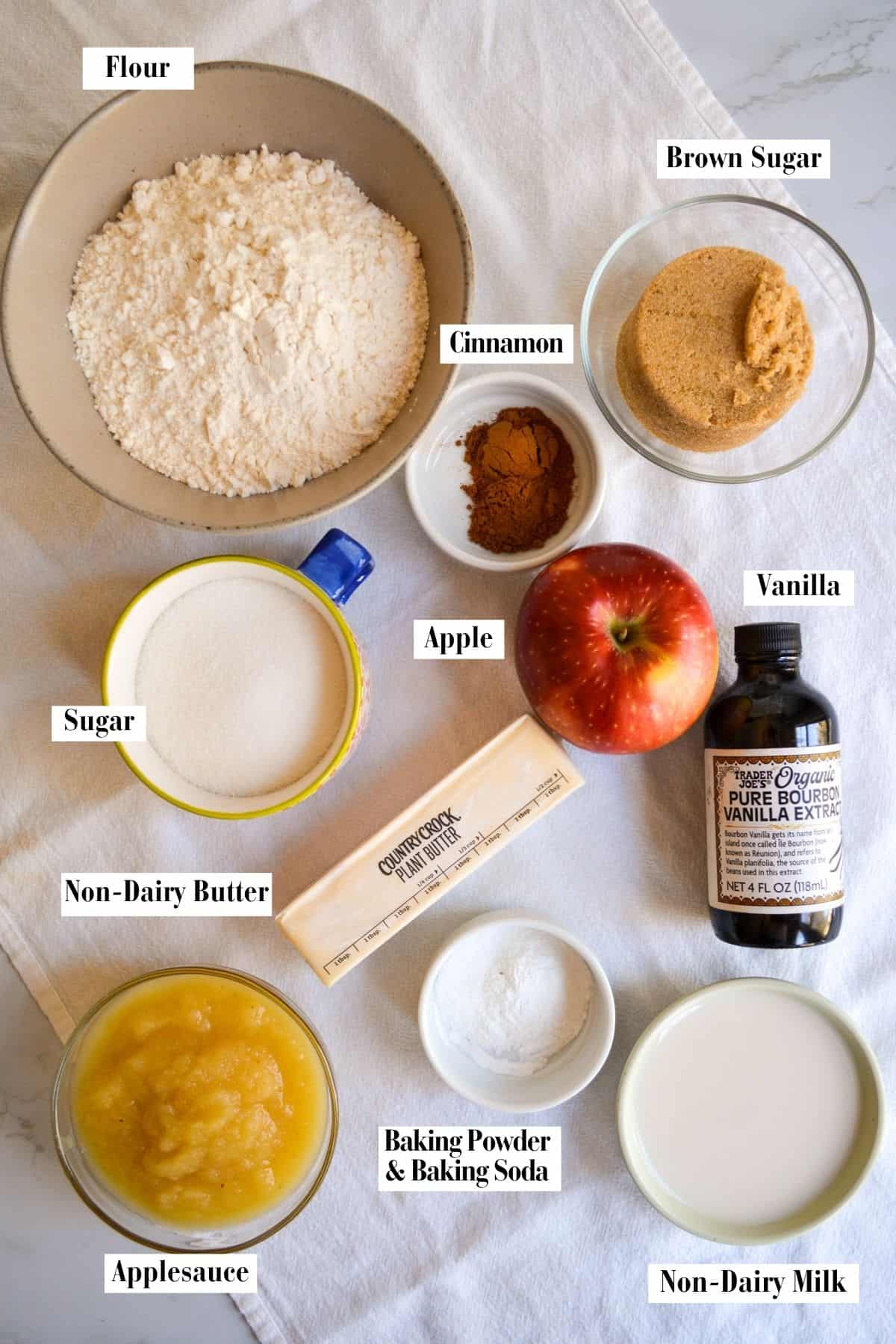 Ingredients for making this recipe in small bowls on a linen surface.