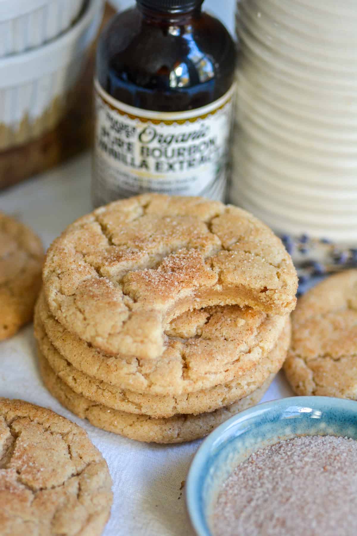 A stack of Vegan Small-Batch Snickerdoodle Cookies with a bite taken out of the top cookie.