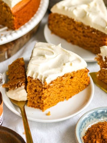 A slice of Vegan Sweet Potato Cake with Maple Frosting on a small plate.
